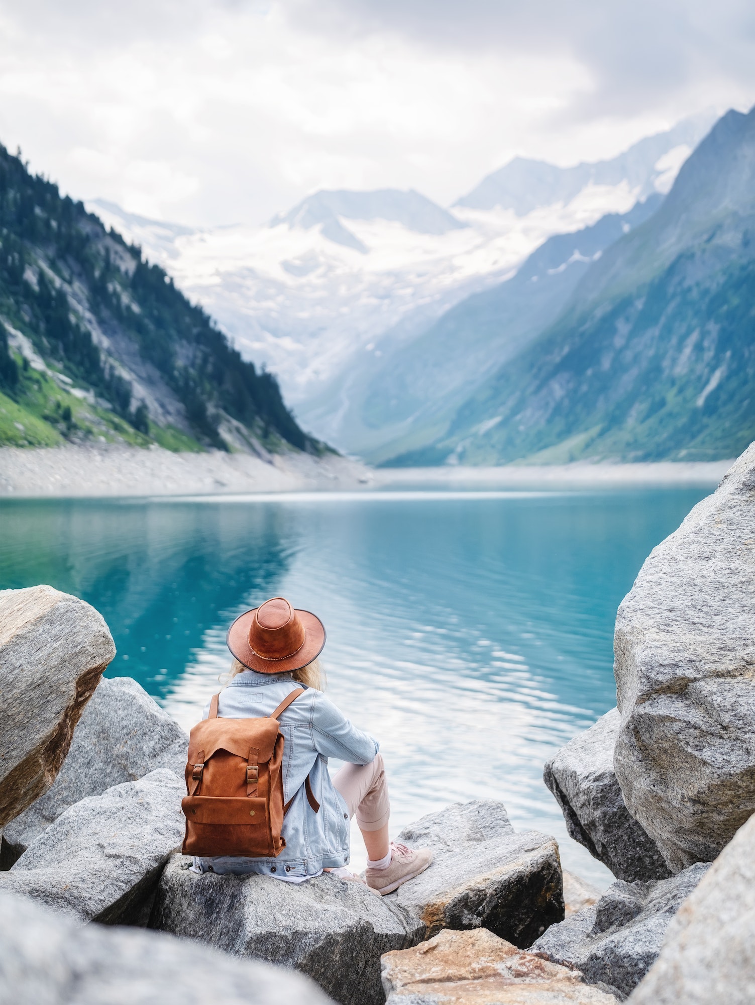 Travel image. Traveler look on the mountain lake. Travel and active life concept.